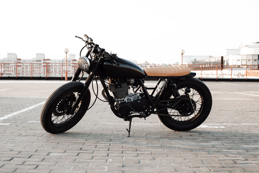 Motorbike. Road and city with open sky on background. Vintage custom motorcycle
